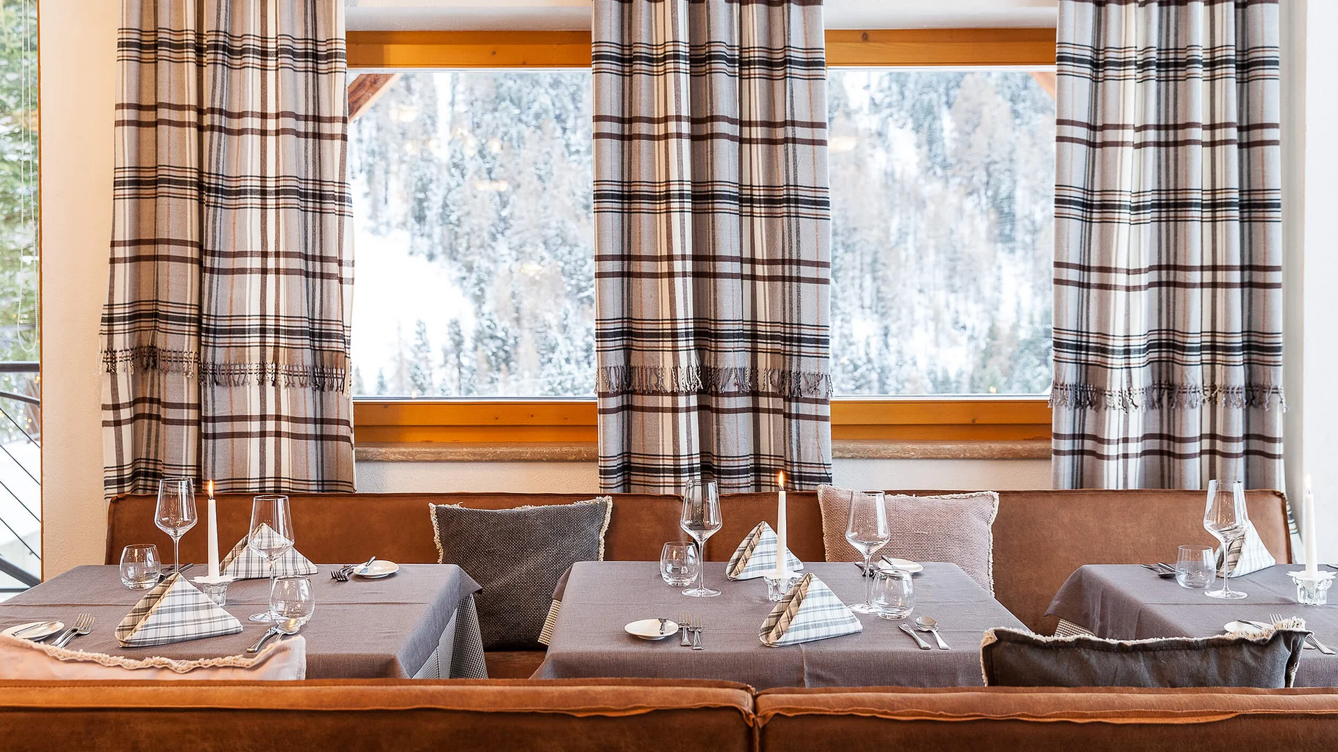 Cozy restaurant with set tables and snowy landscape view