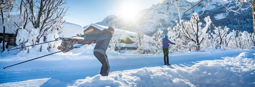 East Tyrol © Martin Lugger Two people cross-country skiing in a snowy mountain landscape with sunshine