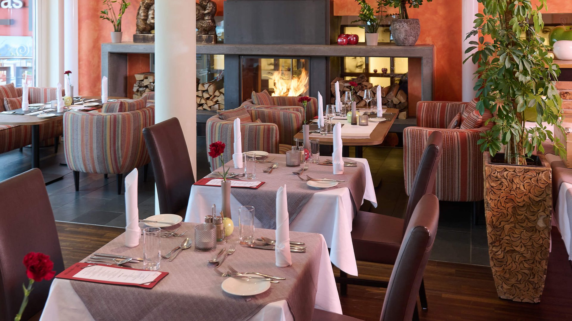 Cozy restaurant with set tables and a fireplace