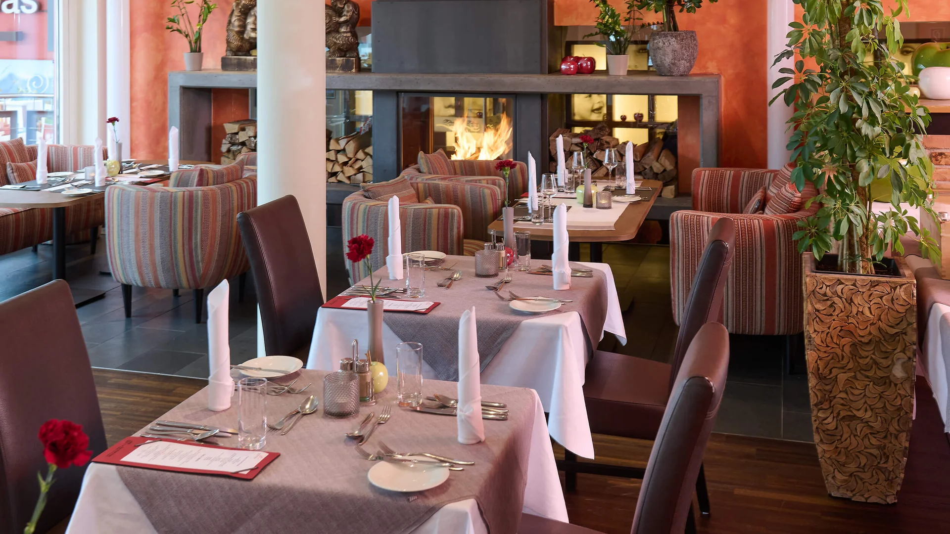 Cozy restaurant with set tables and a fireplace