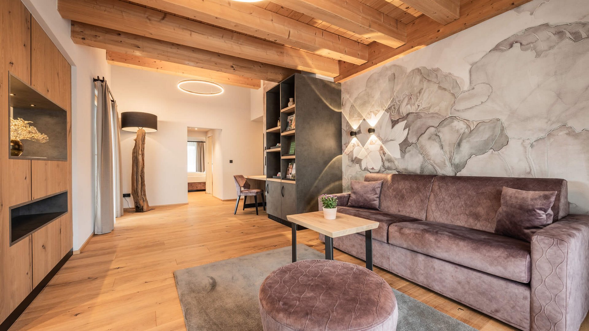 Modern living room with wooden beam ceiling and wall mural