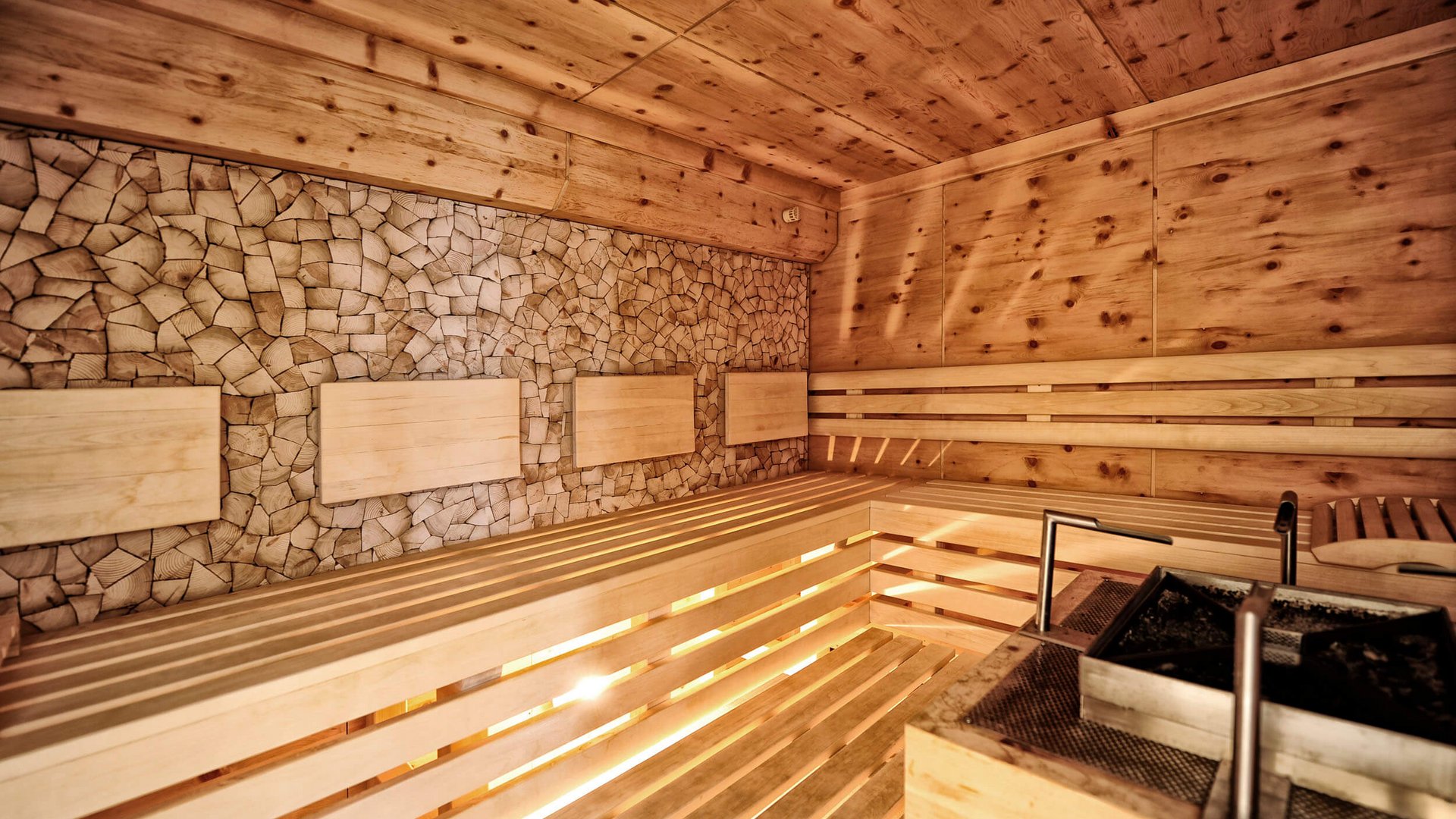 Wooden sauna with benches and modern stove
