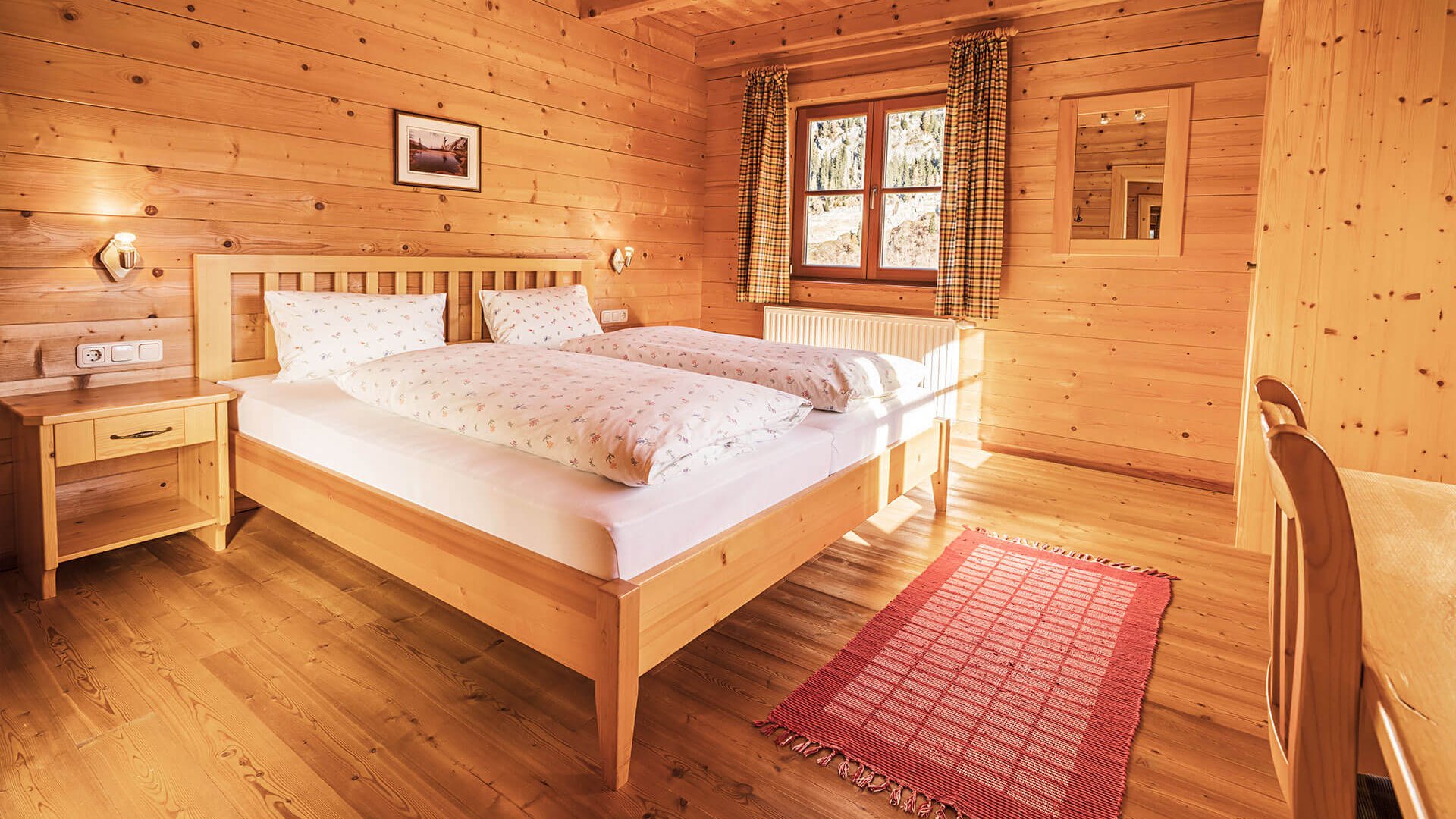 Cozy bedroom with wooden paneling and two single beds