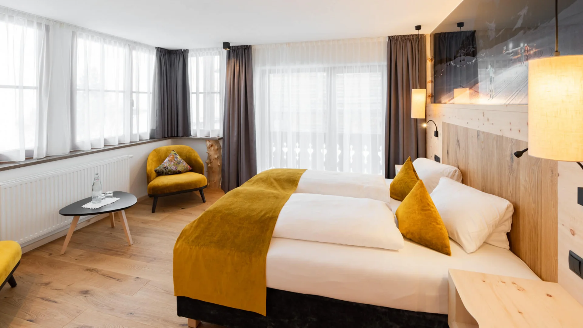 Bright hotel room with double bed and yellow accents