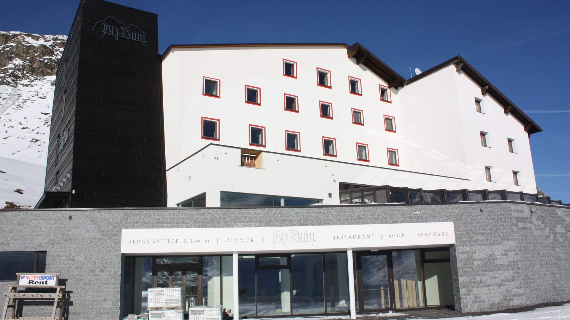Biz Buin mountain inn in snowy alpine landscape under clear blue sky