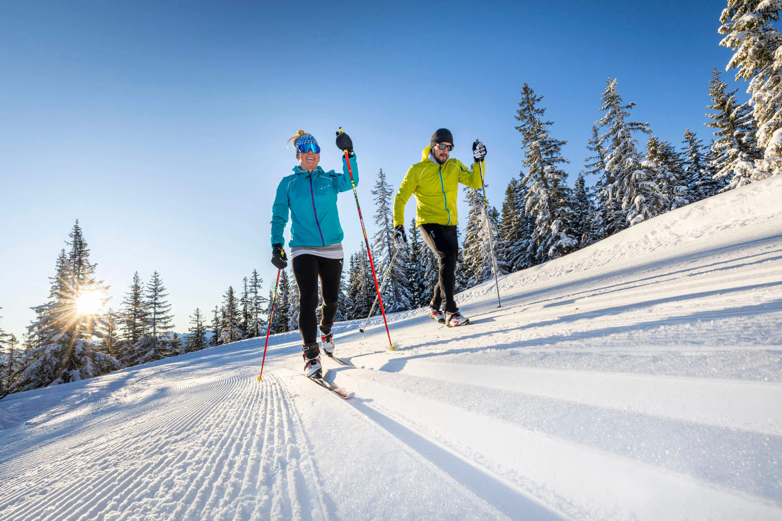Cross-country skiing & wellness © Christian Fischbacher - Filzmoos Tourismus Two people cross-country skiing on a sunny snowy trail