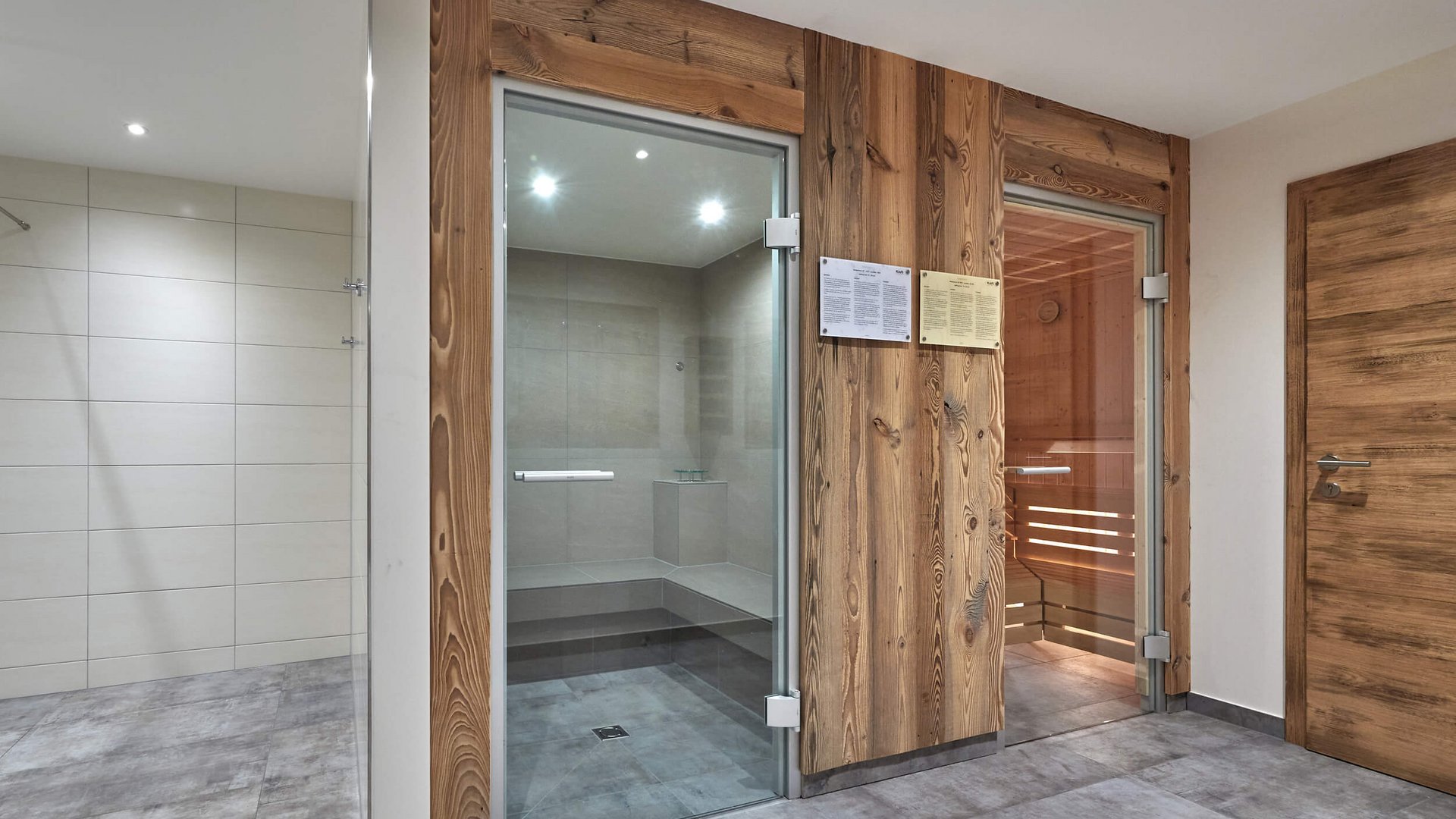 Modern wellness area with steam room and wooden sauna