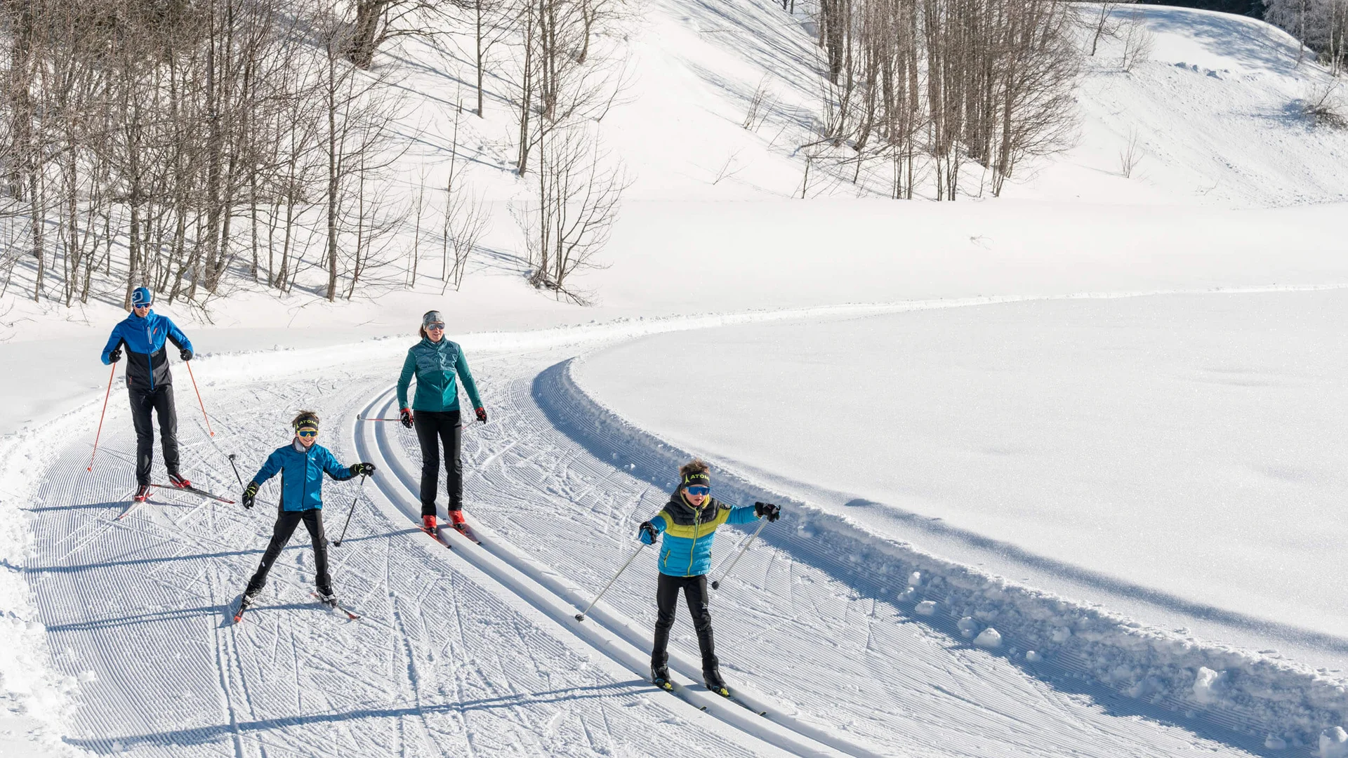 Loipen & Loipenbericht © Lorenz Masser - Filzmoos Tourismus Familie beim Langlauf auf verschneiter Loipe im sonnigen Winterwald