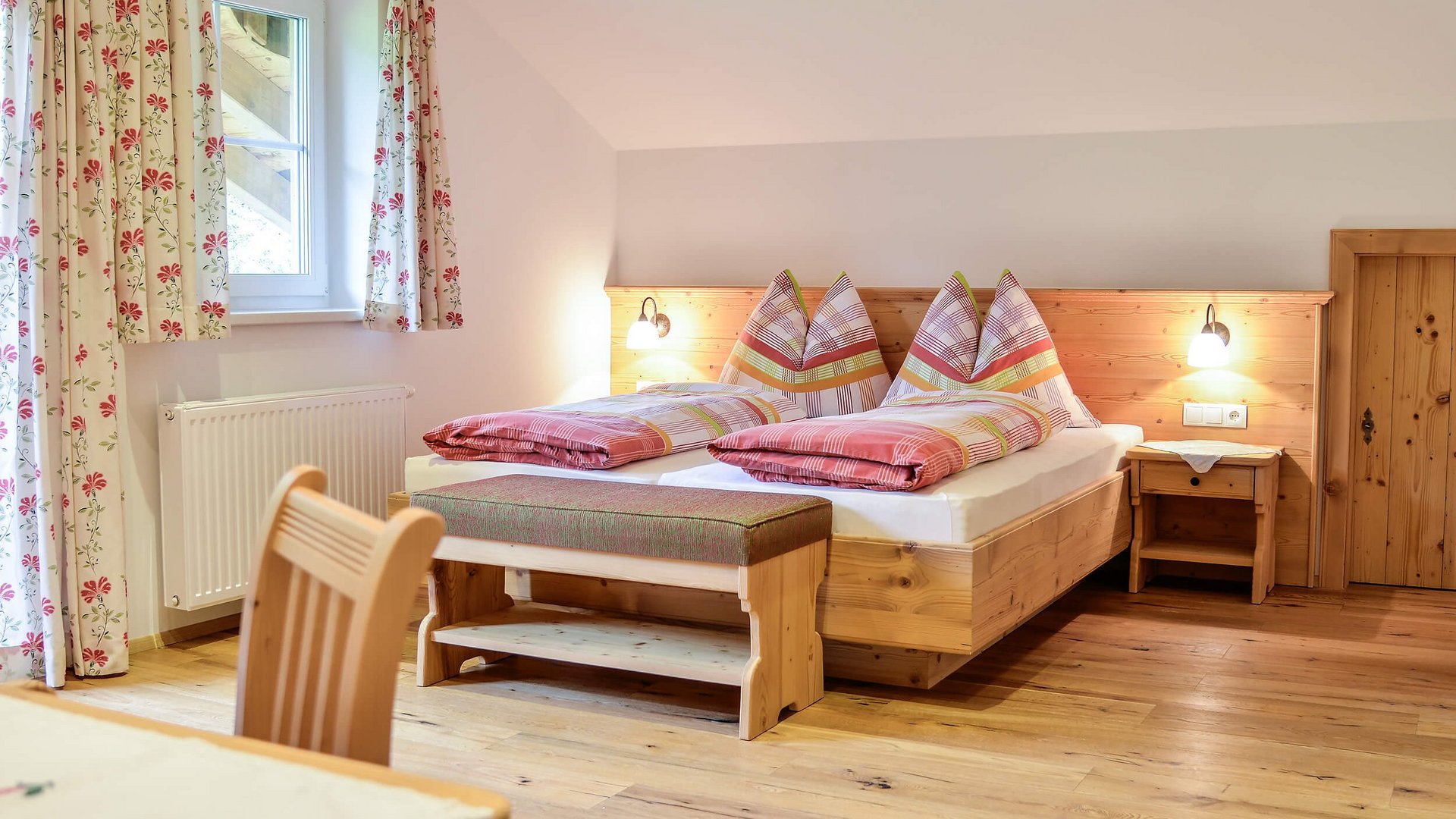 Cozy bedroom with wooden furniture and checkered bed covers