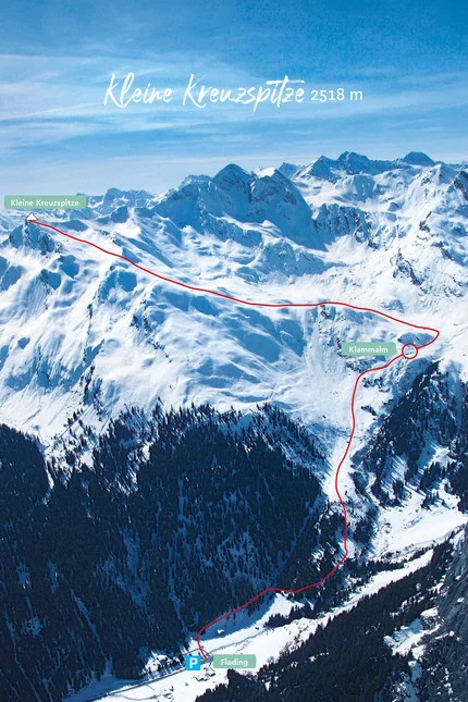 Snow-covered mountain landscape with marked hiking trail to Kleine Kreuzspitze