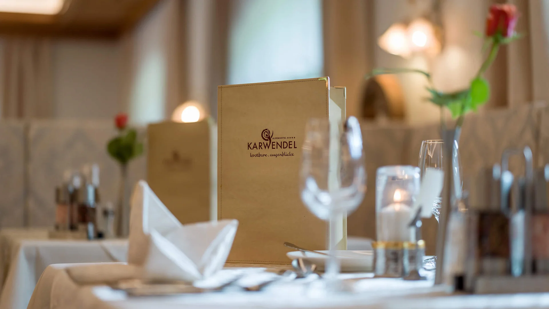 Elegant table setting with menu and rose in Karwendel restaurant