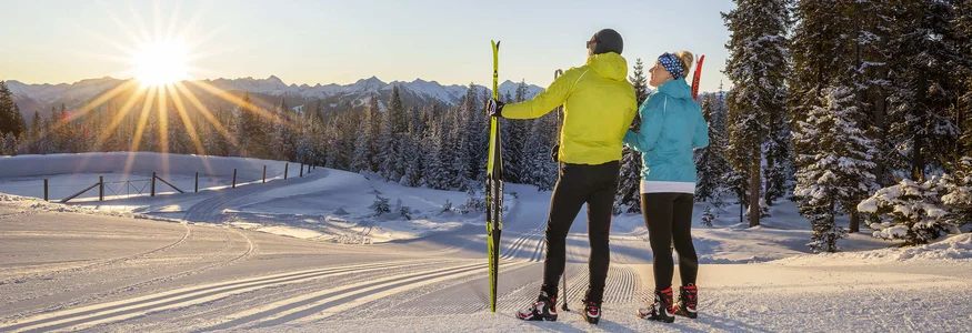 Hotel Sonnenhügel **** © Christian Fischbacher - Filzmoos Tourismus Two skiers enjoying the sunset in a snowy mountain landscape