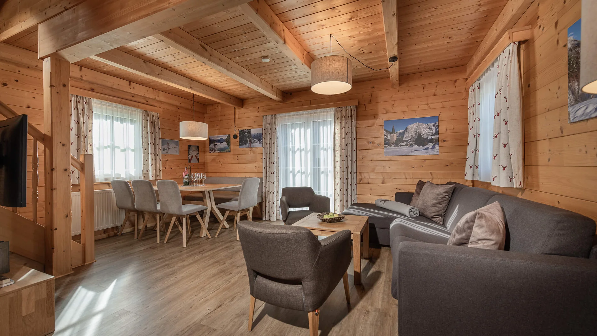 Cozy living and dining area in wooden cabin with sofa and dining table