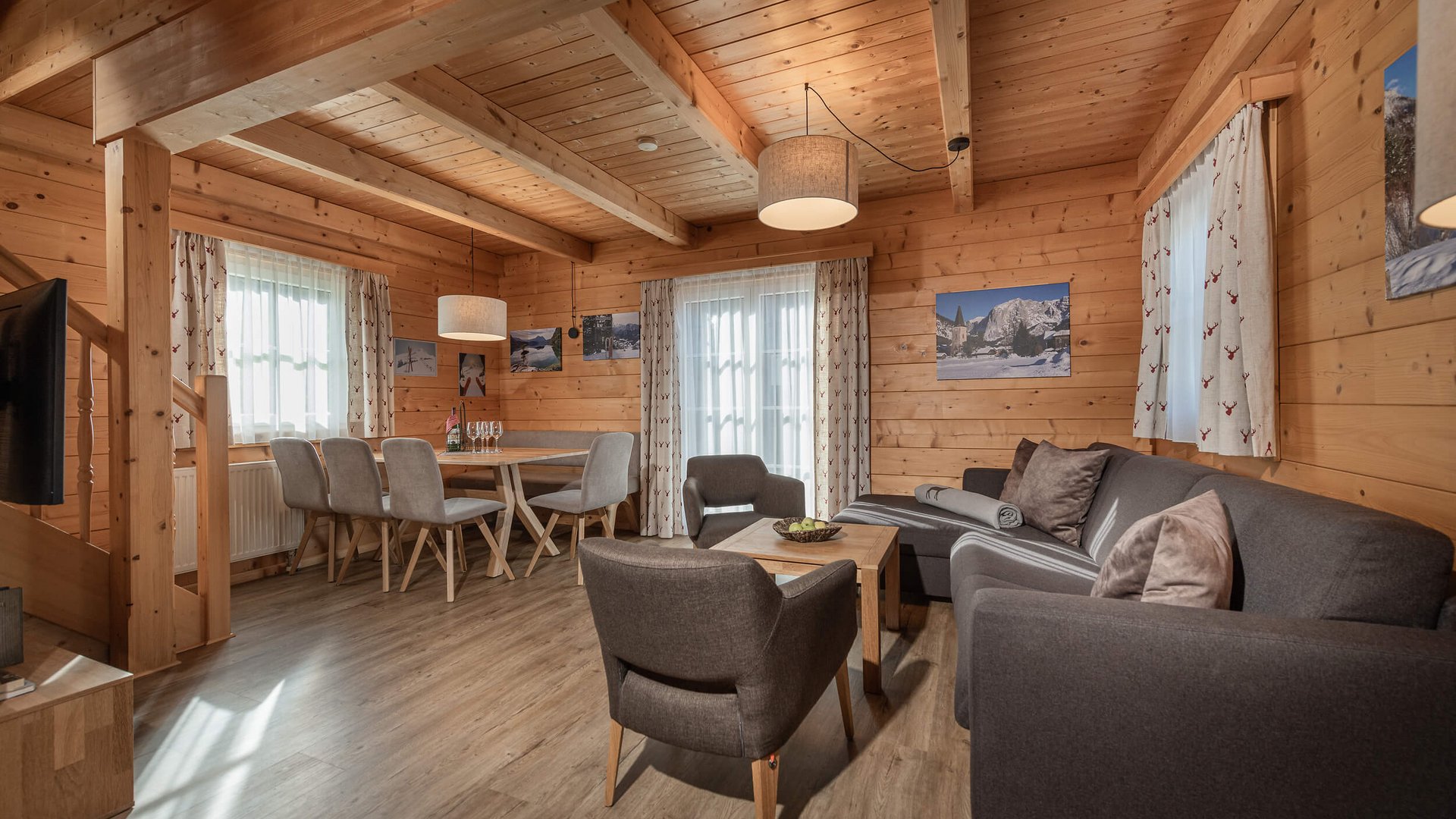 Cozy living and dining area in wooden cabin with sofa and dining table
