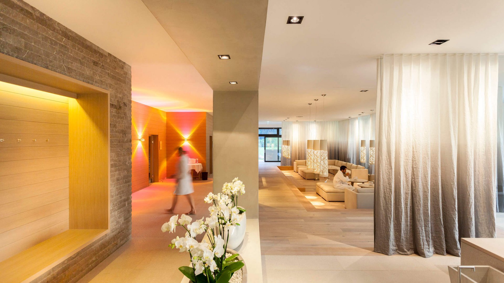 Modern spa lobby with white orchids and relaxing seating areas