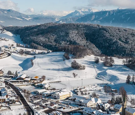 Gitschberg-Jochtal © Hannes Niederkofler Verschneites Dorf zwischen bewaldeten Hügeln und Bergen im Hintergrund