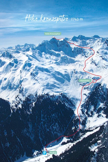 Snow-covered Hohe Kreuzspitze mountain with marked hiking trail and parking at Flading