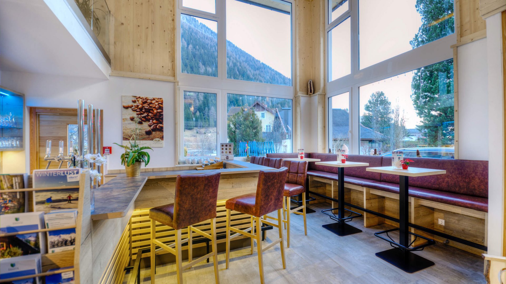 Cozy bar with high chairs and large window showing mountain view