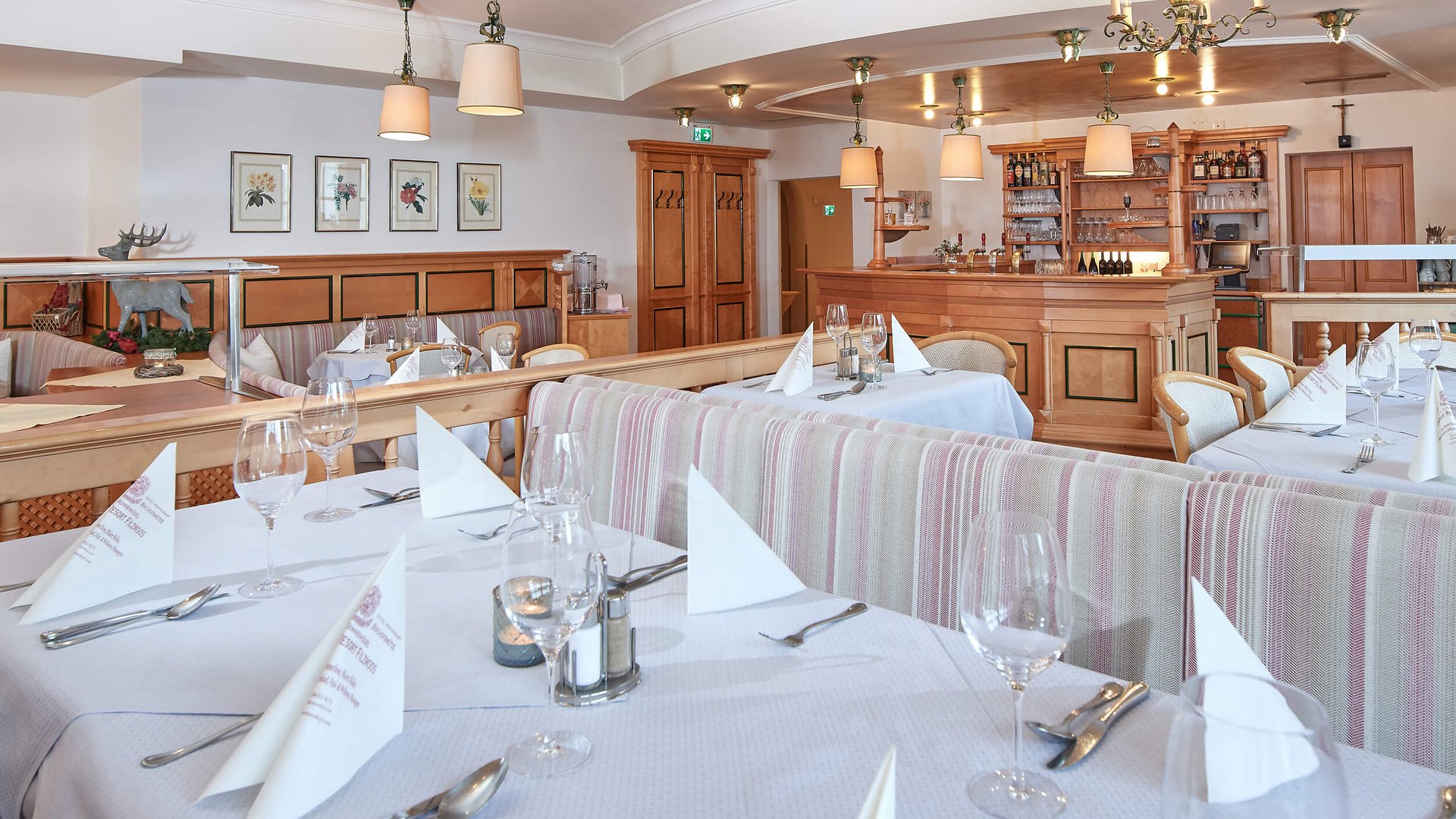 Elegant restaurant with set tables and cozy wooden bar