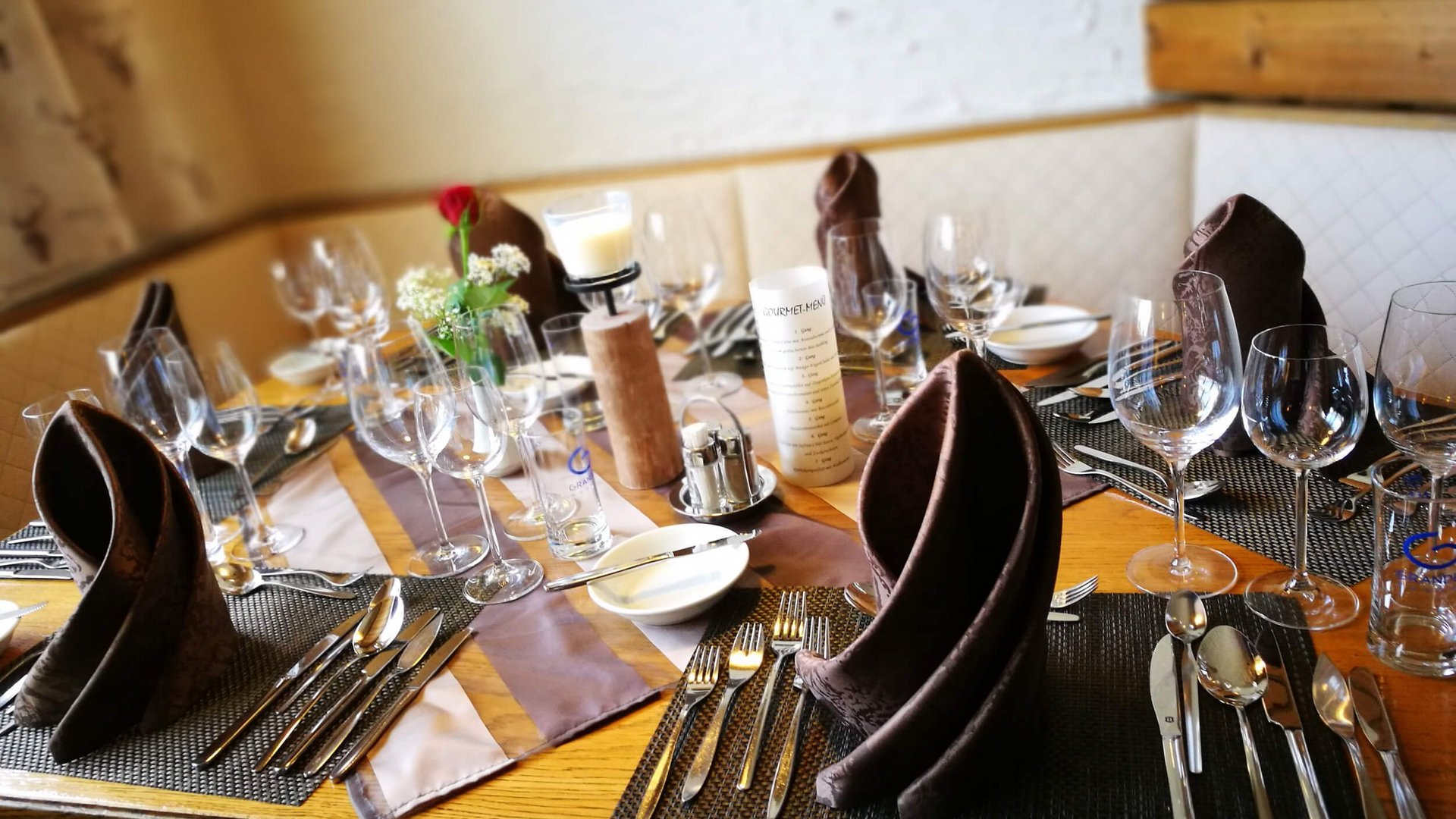 Table set with brown napkins and glassware in an elegant restaurant