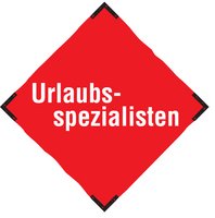 Rotes Schild mit weißer Aufschrift Urlaubsspezialisten