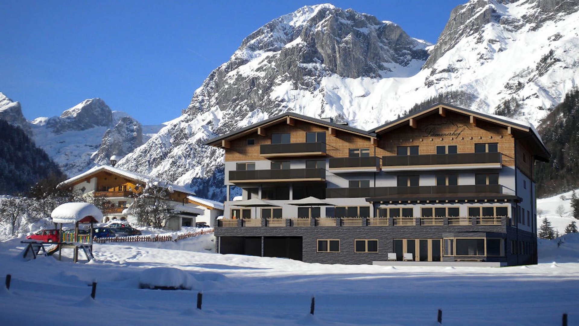 Hotel in verschneiter Berglandschaft unter blauem Himmel