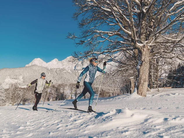 Schneesicher langlaufen: Wo Snowfarming in Österreich frühen Saisonstart möglich macht
© TVB Schladming Dachstein - Christine Höflehner Zwei Personen beim Langlaufen vor verschneiten Bergen und klarem Himmel