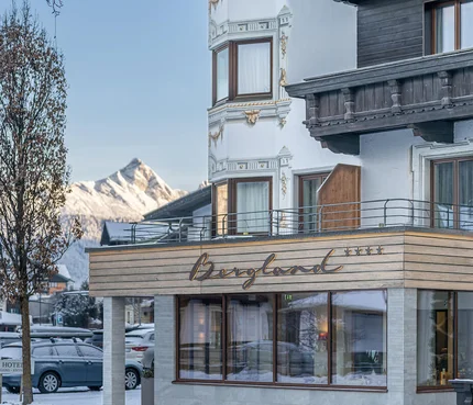 Hotel Bergland with snow-covered mountains in the background