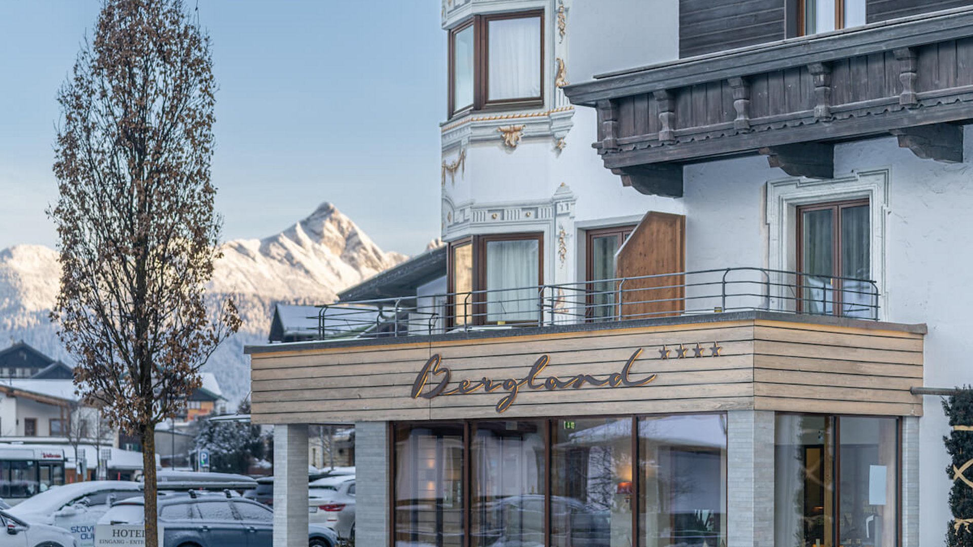 Hotel Bergland with snow-covered mountains in the background