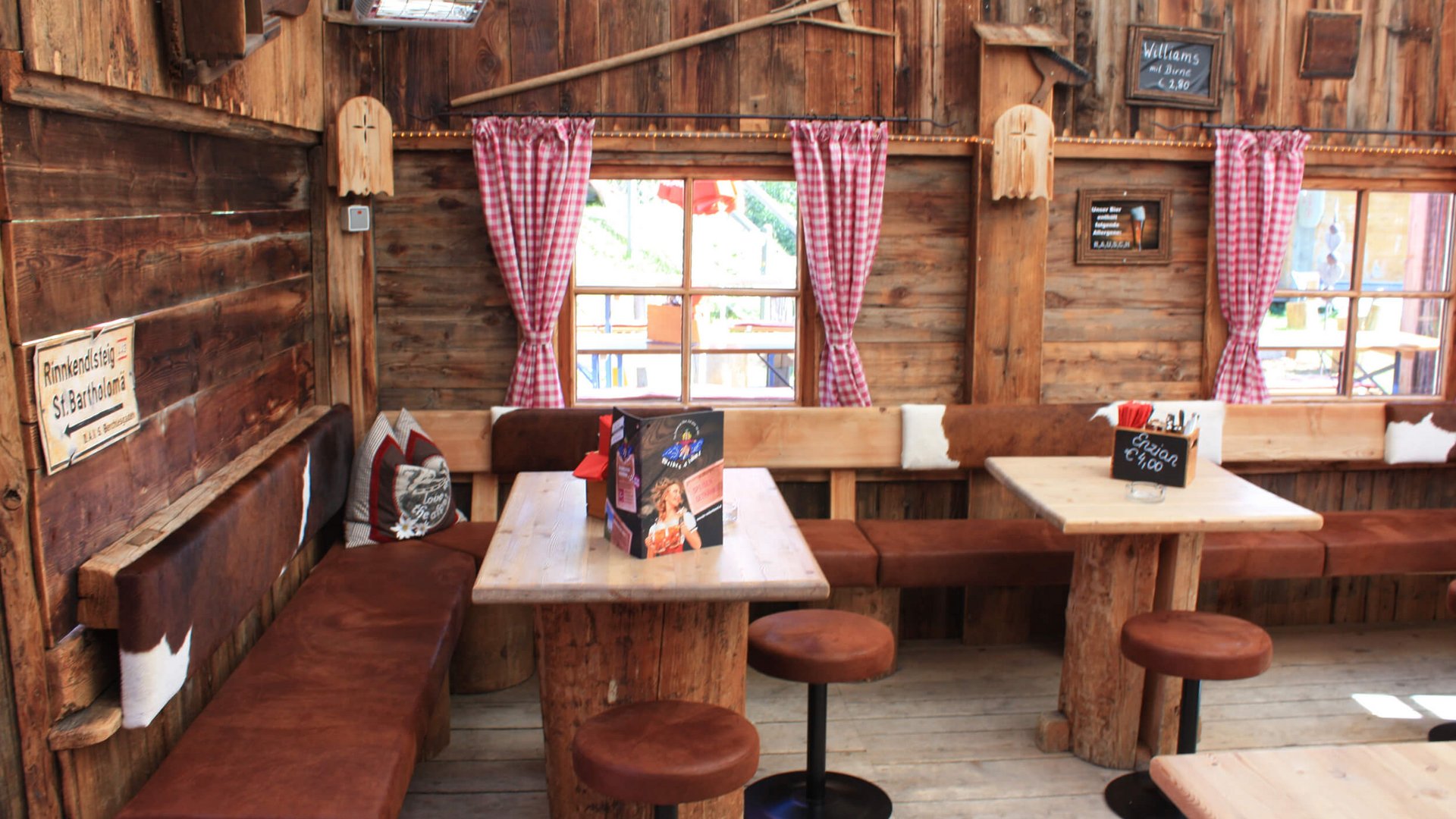 Cozy wooden cabin interior with tables and benches in alpine style